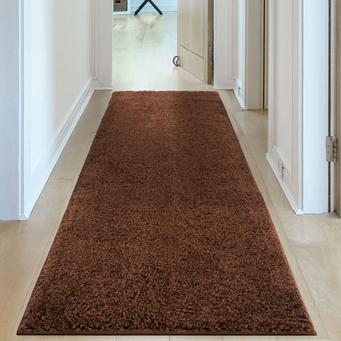 A plush myshaggy solid brown rug with a shaggy chocolate brown textured surface perfect as a runner brown rug