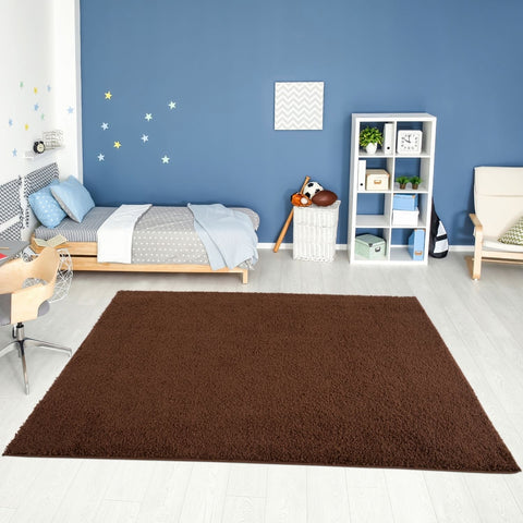 A plush myshaggy solid brown rug with soft shaggy texture lies centered on a light floor as a cozy brown rug