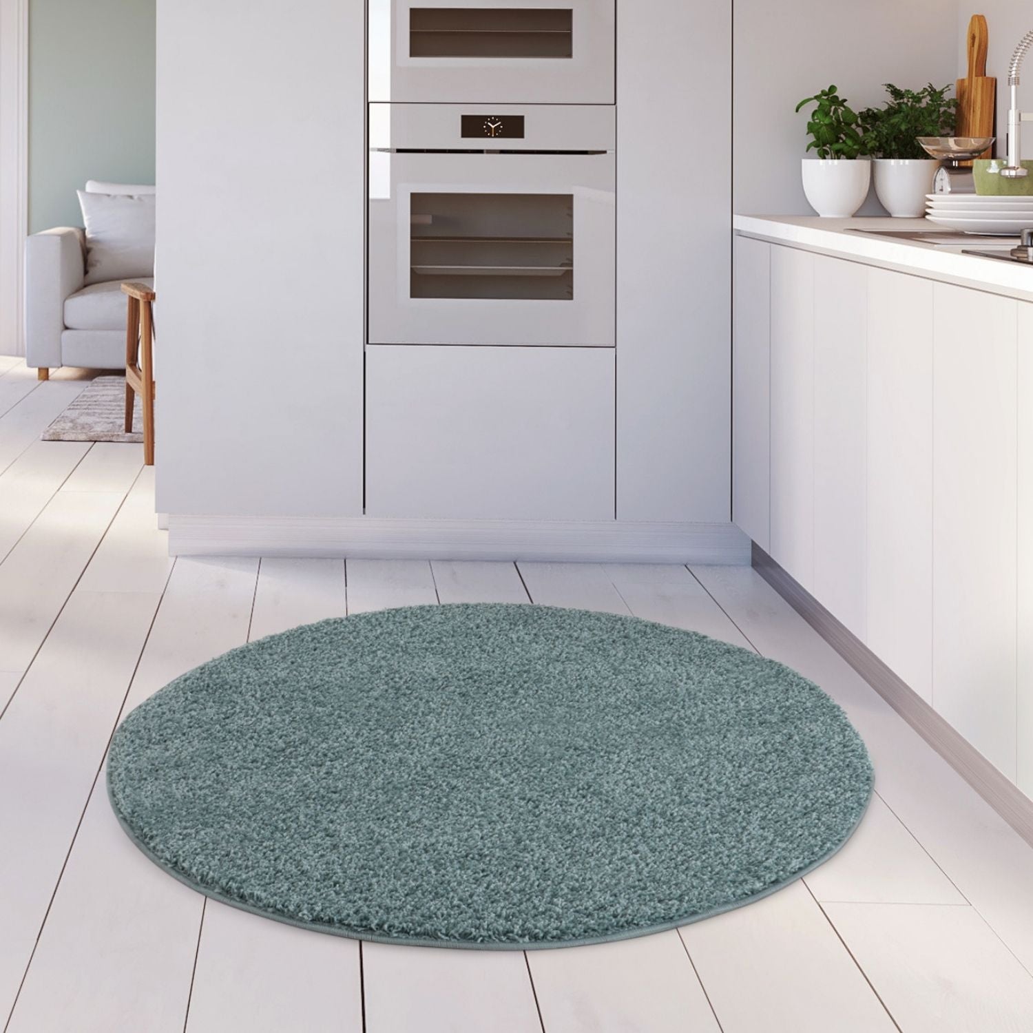 Circular teal shaggy rug with plush textured surface in duck egg blue perfect for cozy home decor