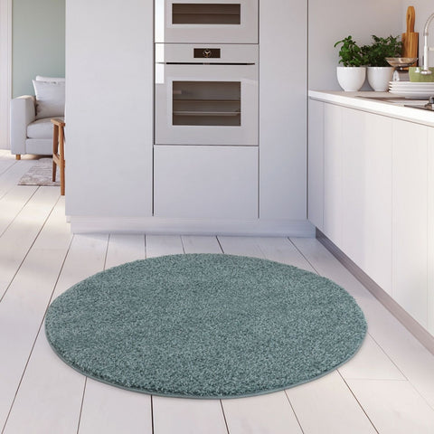 Circular teal shaggy rug with plush textured surface in duck egg blue perfect for cozy home decor
