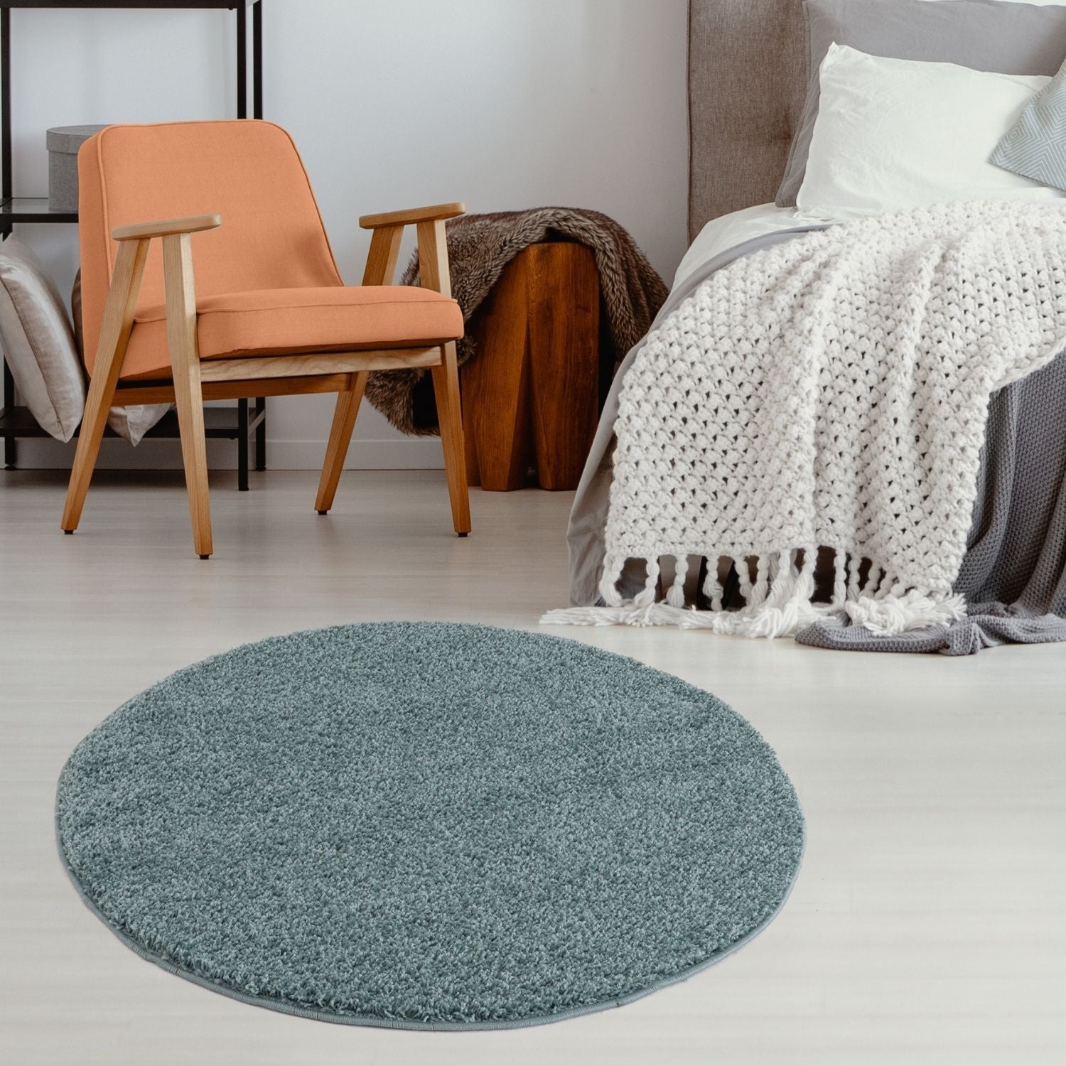 Circular teal shaggy rug with plush texture and trimmed edges in a soft duck egg blue perfect for cozy spaces