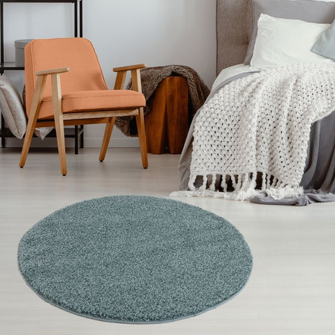 Circular teal shaggy rug with plush texture and trimmed edges in a soft duck egg blue perfect for cozy spaces