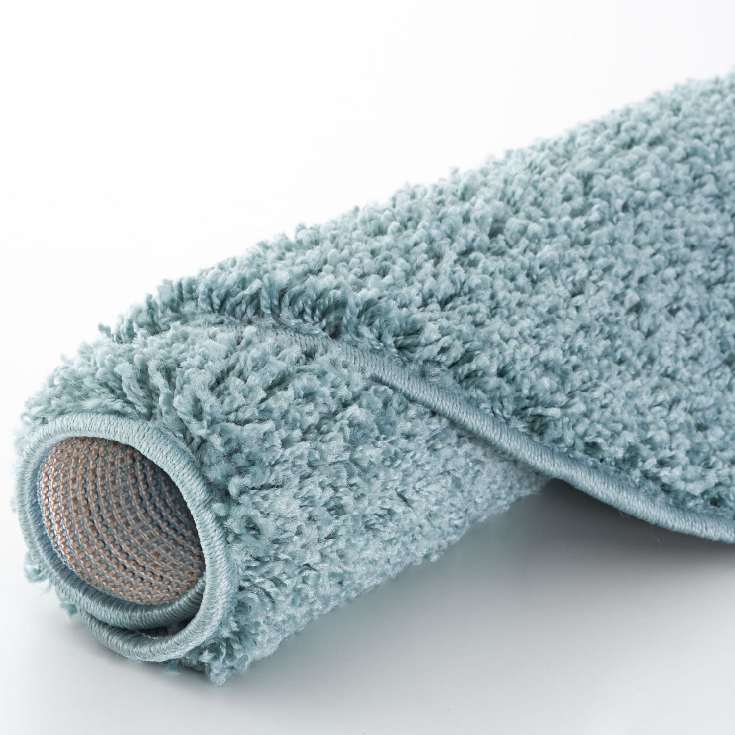 A plush duck egg blue bath mat with soft shaggy texture and woven backing perfect for cozy bathroom floors