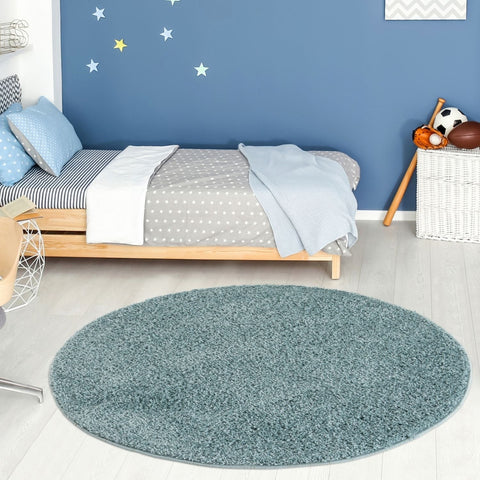 A plush round duck egg blue shag rug with a soft textured surface perfect for cozy home spaces