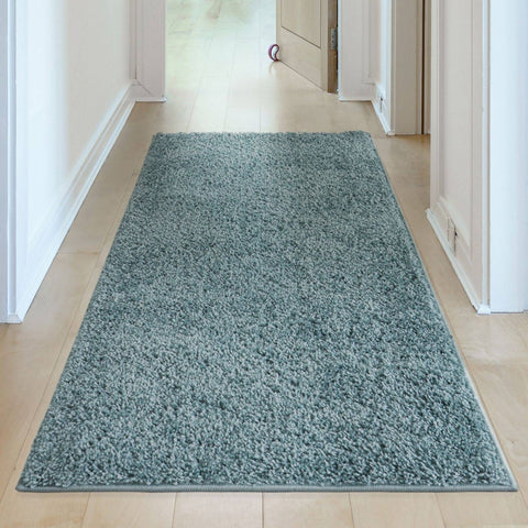 A plush teal duck egg blue shaggy rug with a soft textured surface and neatly finished edges perfect for cozy spaces