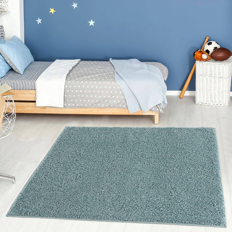 A plush teal shag rug with a soft textured surface in duck egg blue perfect for cozy home decor