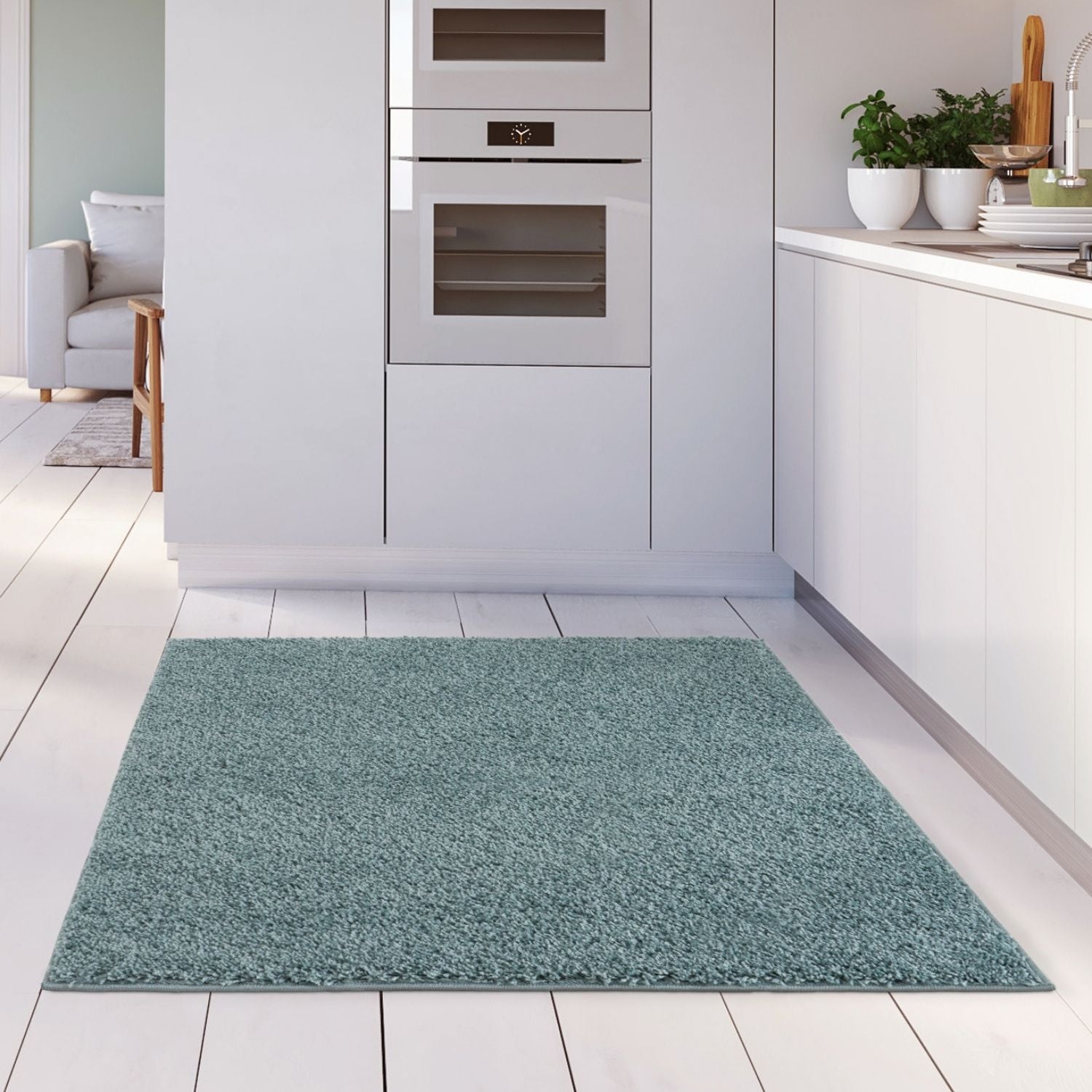 A plush teal shaggy duck egg blue rug with a soft textured surface on a white tiled floor perfect for cozy spaces
