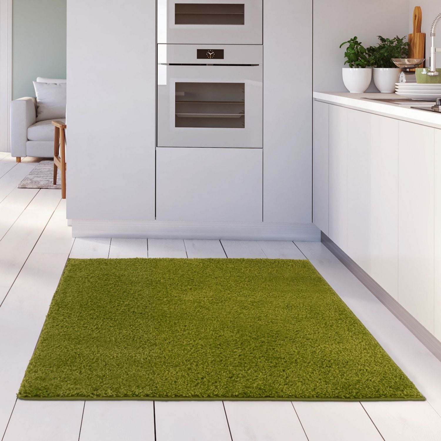 A plush 30mm pile myshaggy solid green rug with a soft shaggy texture on a white wooden floor