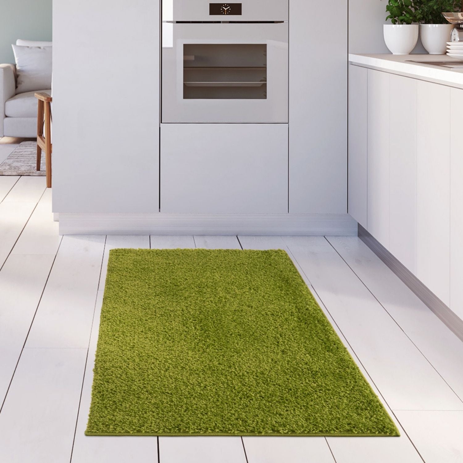 A plush solid green rug with a vibrant color and soft shaggy 30mm pile lies on a white wooden floor