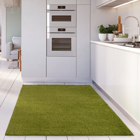 Myshaggy solid green rug with plush 30mm pile features a vibrant solid green color and soft shaggy texture on white tiles