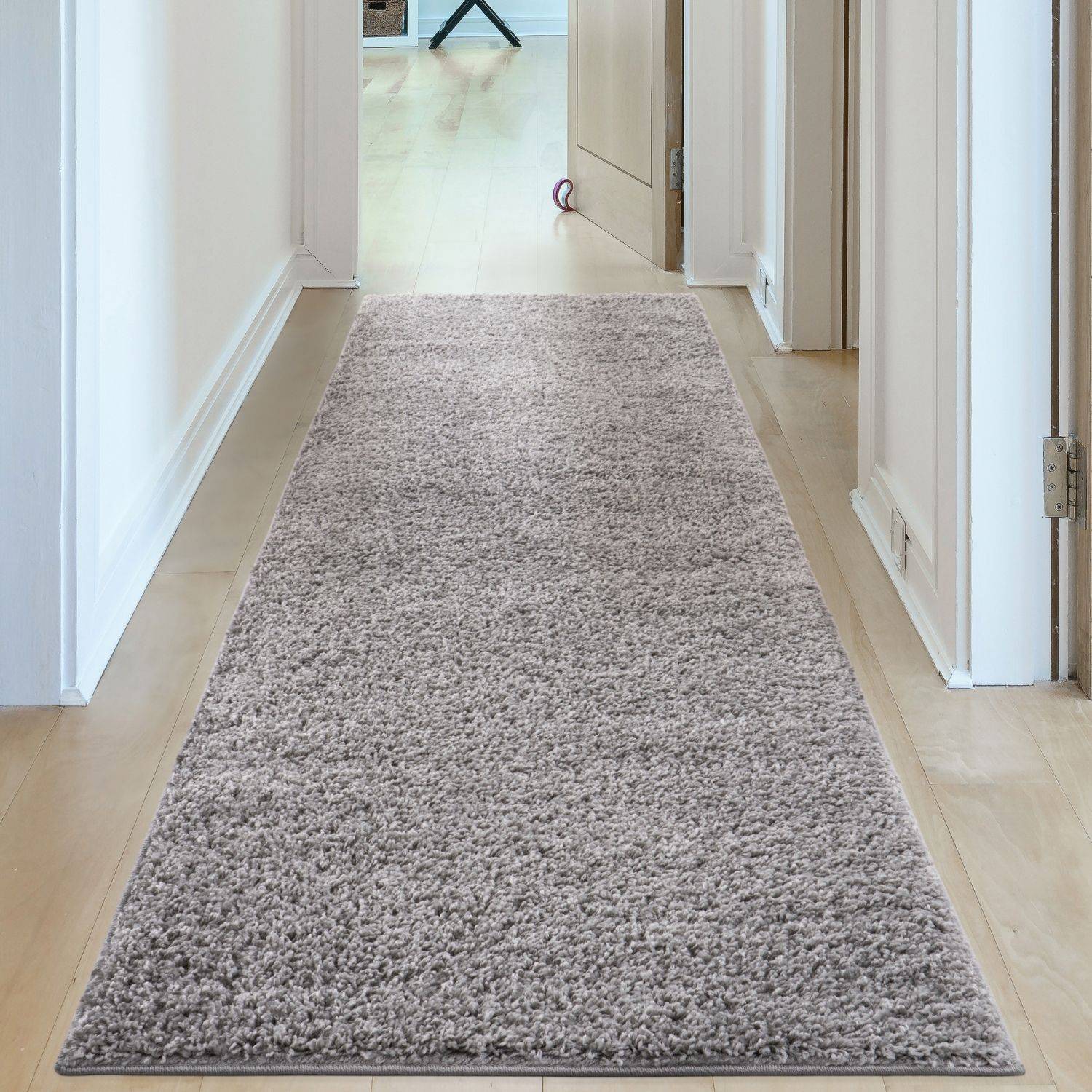 A plush light gray shaggy runner rug with a soft textured surface perfect as a myshaggy solid grey rug