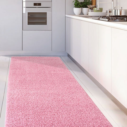 A soft plush shaggy myshaggy solid pink rug lies on the kitchen floor adding cozy solid pink rug vibes