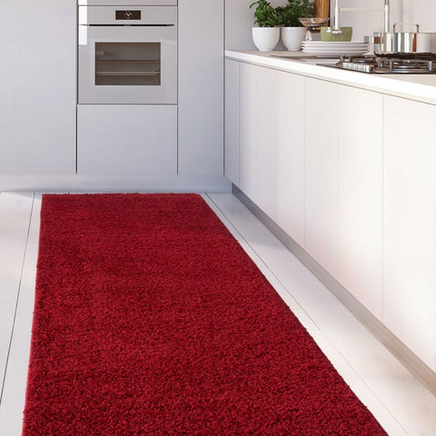A plush myshaggy solid red shaggy rug with a soft textured surface on a kitchen floor perfect for cozy spaces