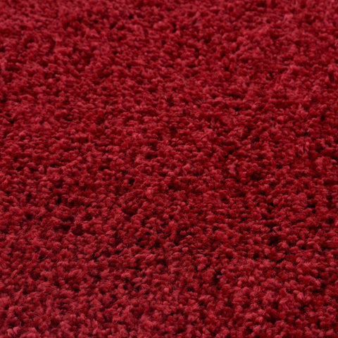 Myshaggy solid red rug with a rich crimson color and plush shaggy textured surface for cozy home style