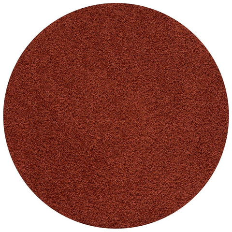A circular textured brown abrasive pad perfect for use with the myshaggy solid terra rug for easy cleaning