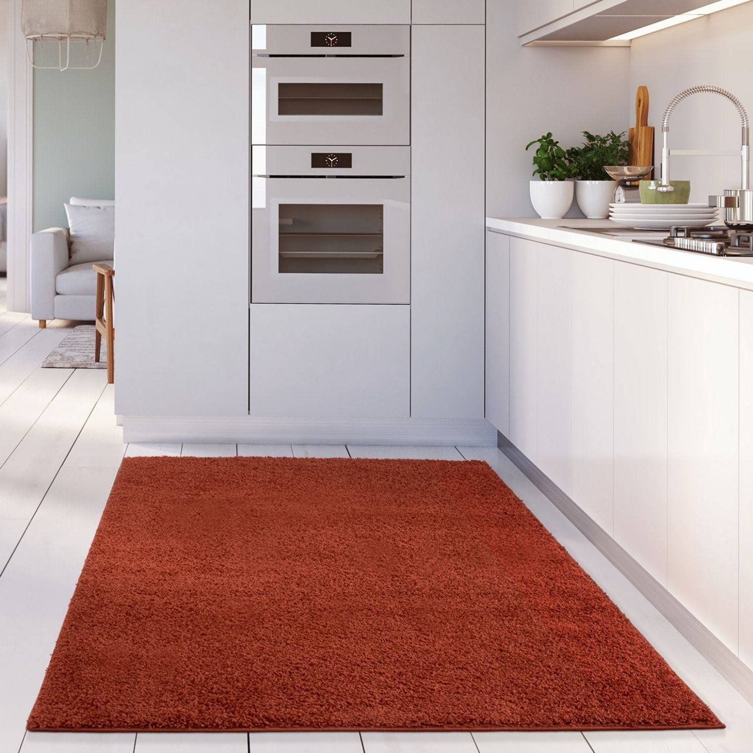 A plush rust-colored myshaggy solid terra rug with soft shaggy texture on a white tiled floor