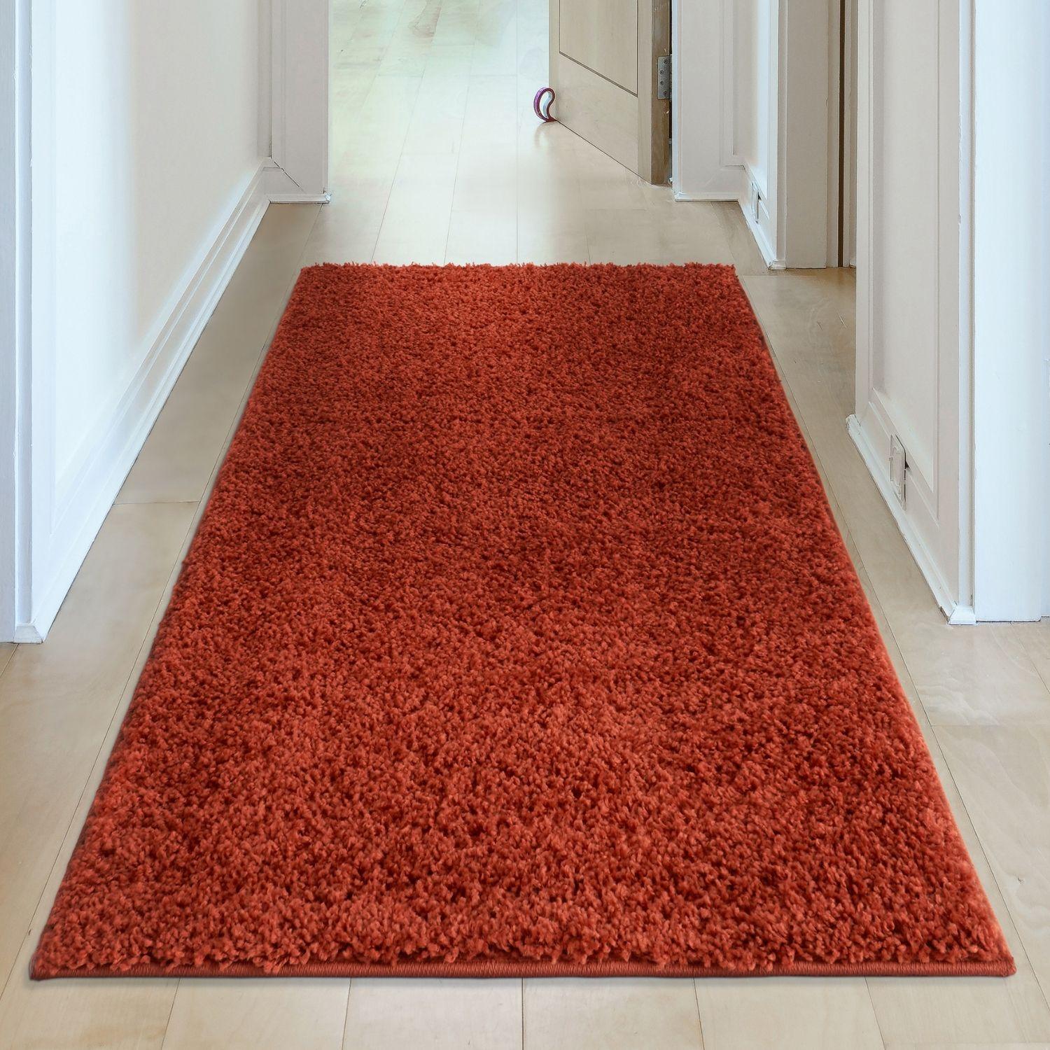 A plush vibrant orange shaggy rug with soft textured surface and neat edges called myshaggy solid terra rug