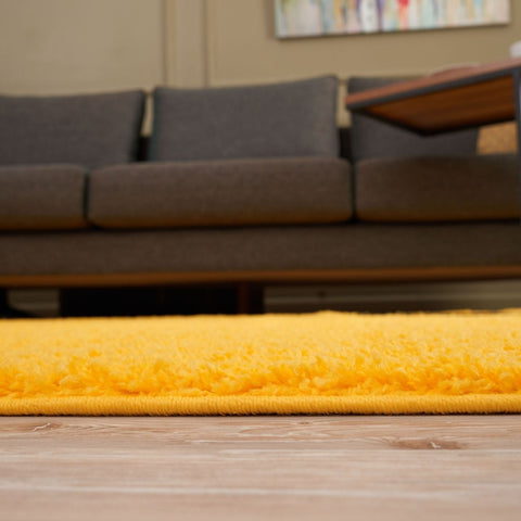 Myshaggy solid yellow rug is a bright yellow plush shaggy rug with a soft textured surface perfect for cozy spaces