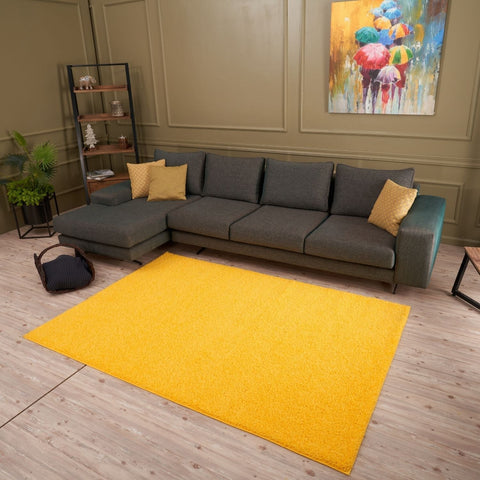 Vibrant yellow rectangular myshaggy solid yellow rug with plush shaggy texture and soft pile for cozy spaces