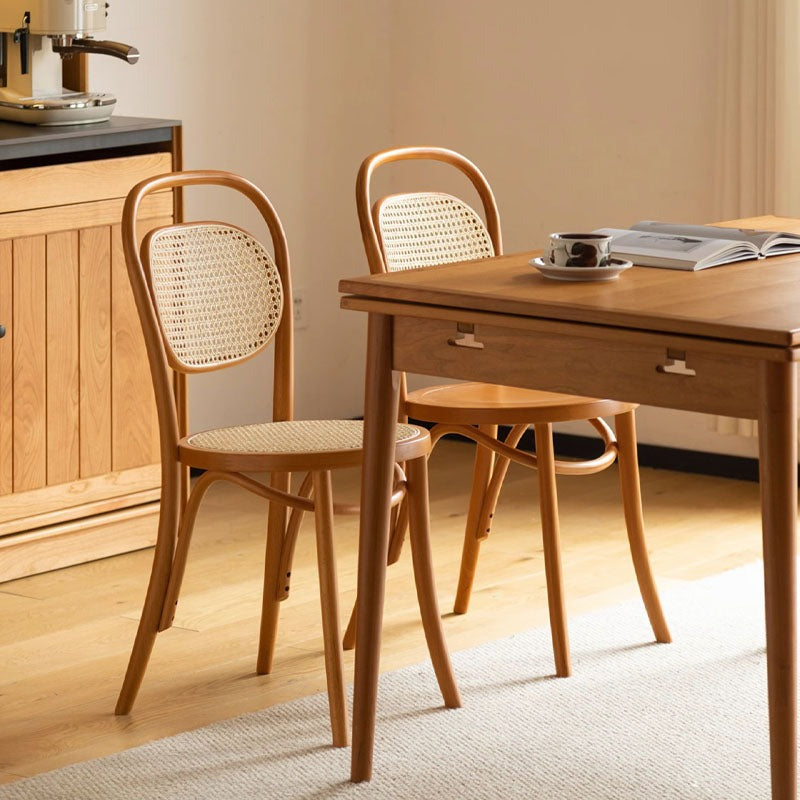 Light wood nadia rattan dining chair with cane back curved frame and woven seat perfect for dining room use