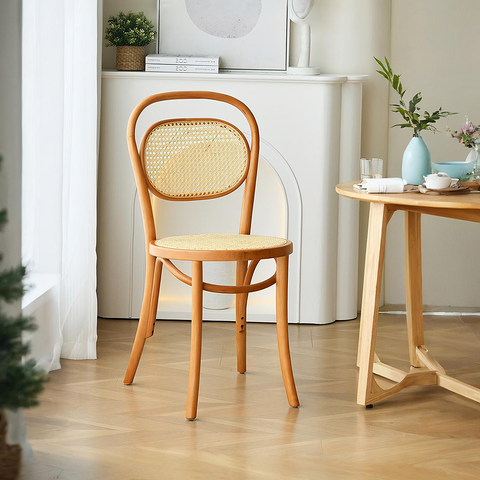 A light wood framed nadia rattan dining chair with woven natural rattan back and seat perfect for dining