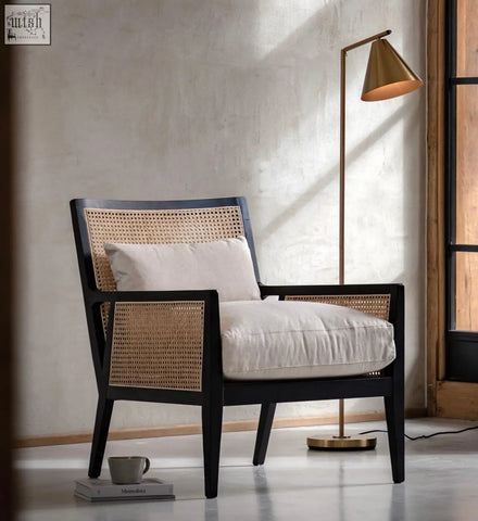 Nagoya rattan arm chair in black frame with woven cane back and sides and cream cushions for comfy seating