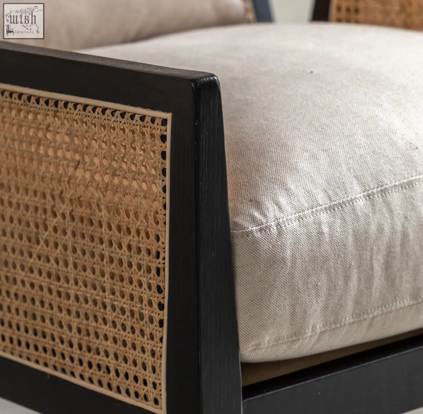 Nagoya rattan arm chair with black cane-back frame and light beige cushion perfect for natural style seating