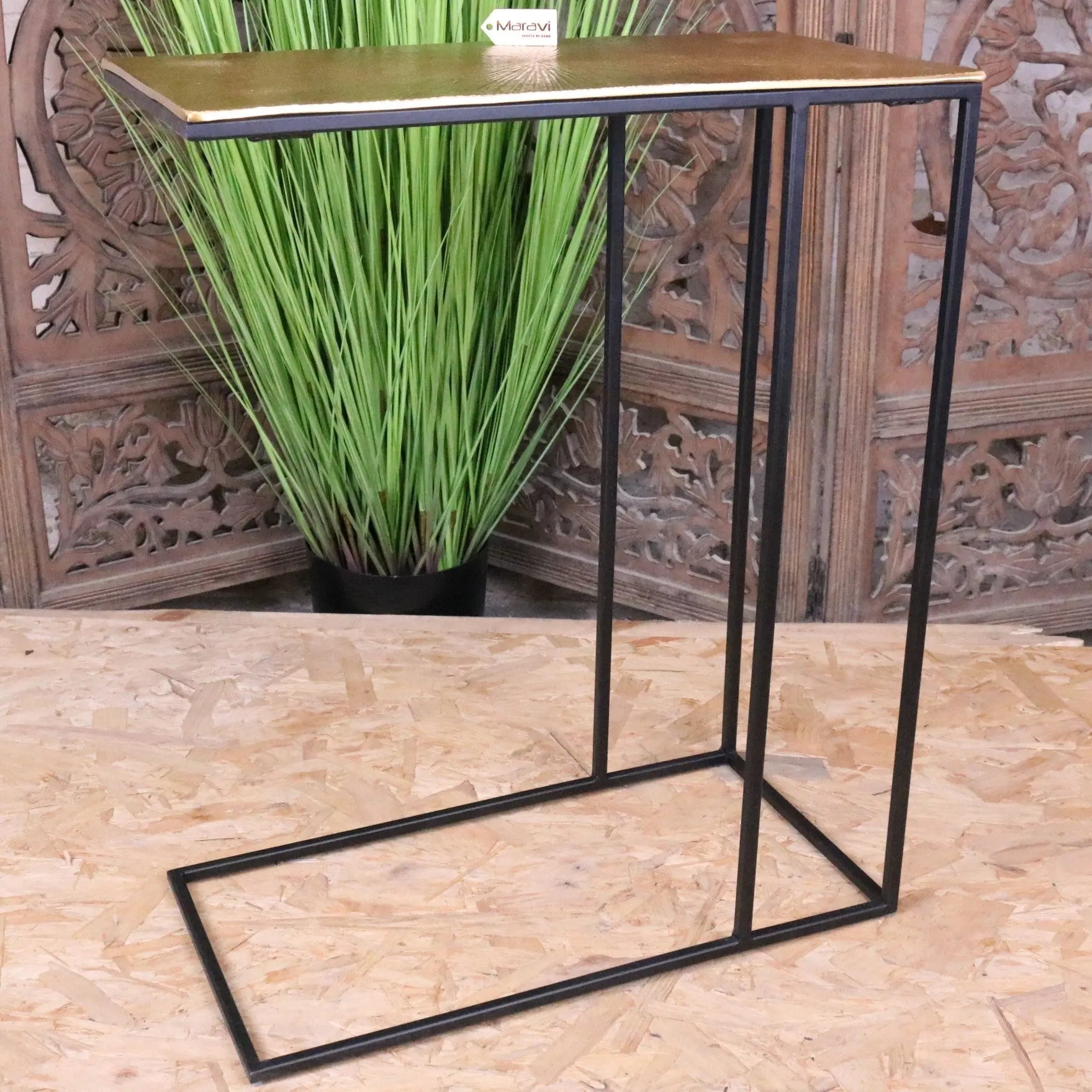 Modern black metal sofa table with a rectangular gold finished top perfect as a stylish gold sofa table