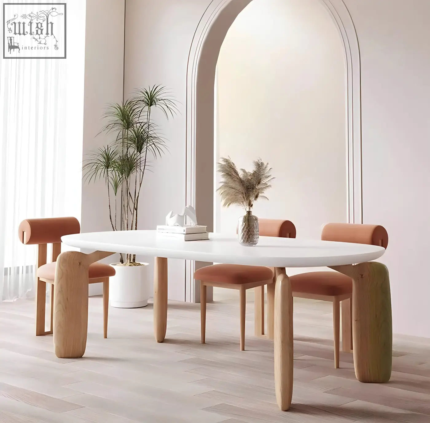 White oval namie dining table with light wood legs and matching chairs with orange upholstered seats