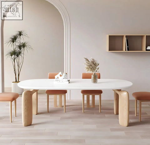 White oval namie dining table with sculpted light wood legs and smooth minimalist surface for modern dining
