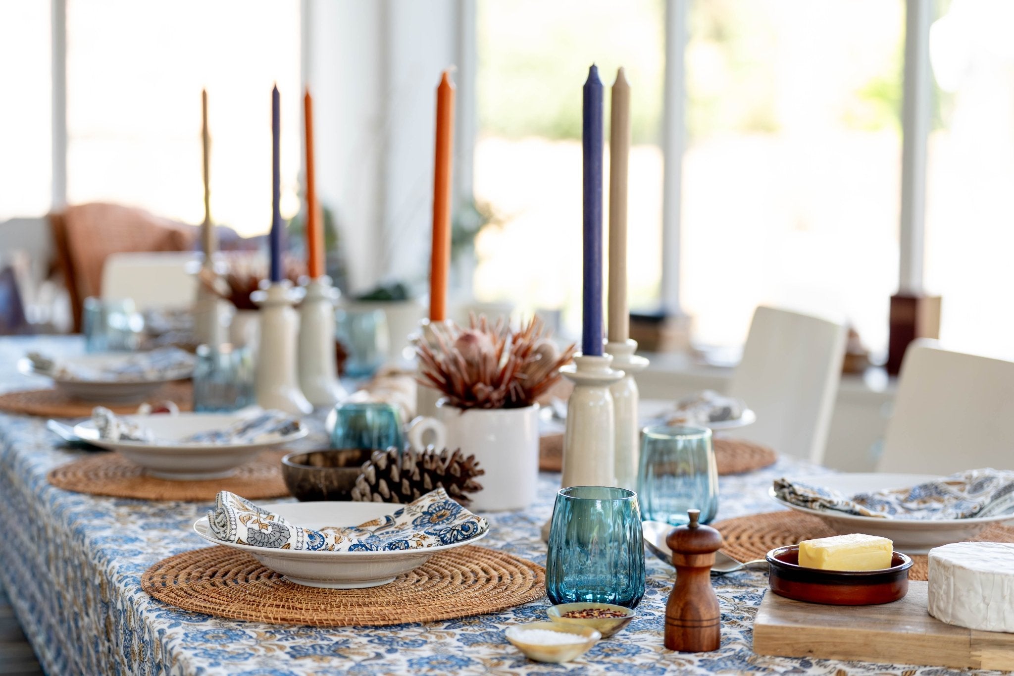 A blue glass candle holder with a white ceramic base for the napkins set of 4 coromandel nut blue