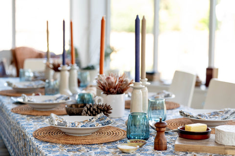A blue glass candle holder with a white ceramic base for the napkins set of 4 coromandel nut blue