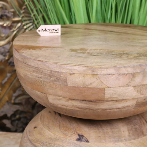 A round light-toned narmada swirl mango wood side table with stacked rustic design and visible wood grain
