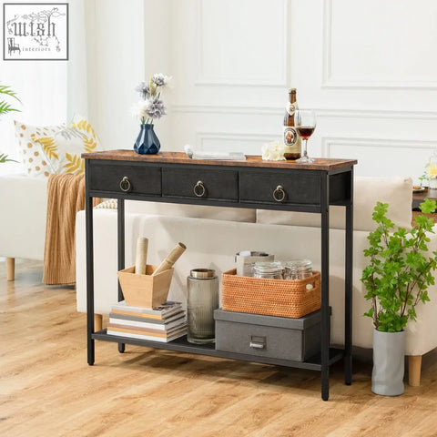 Black console table with rustic wood top and three drawers with round metal handles for a narrow entryway with antique appearance