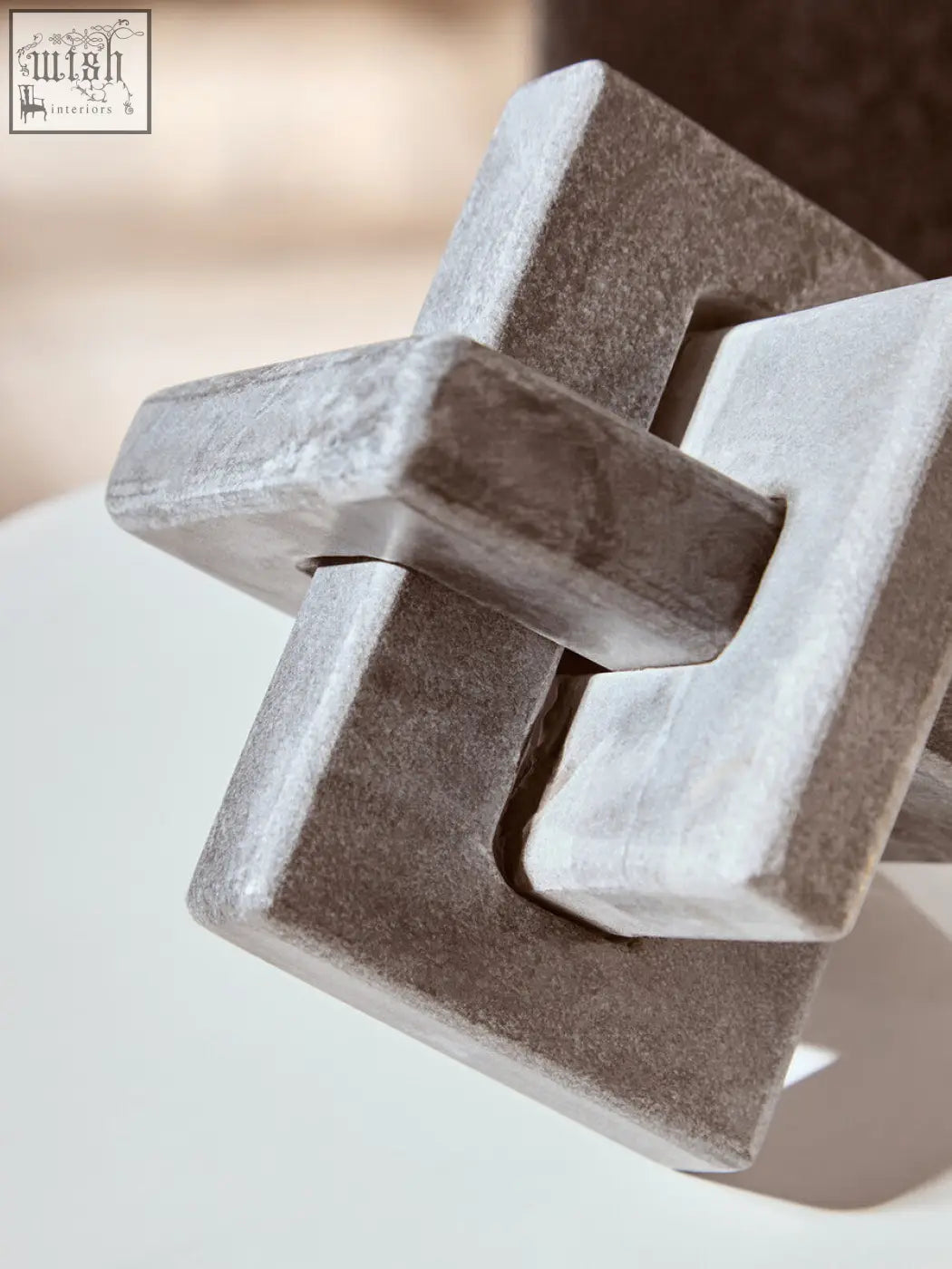 Gray stone puzzle cube made of grey marble in a grey marble knot design perfect as a marble knot sculpture