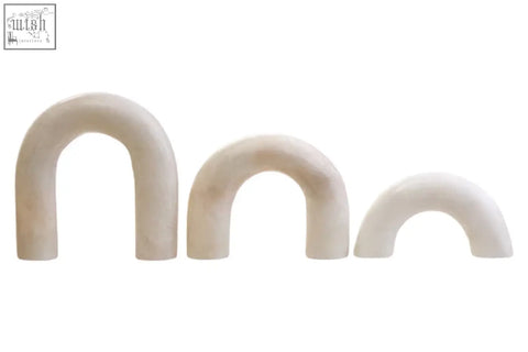 Three cream-colored white marble arch decor sculptures with smooth surfaces and subtle veining in varying sizes