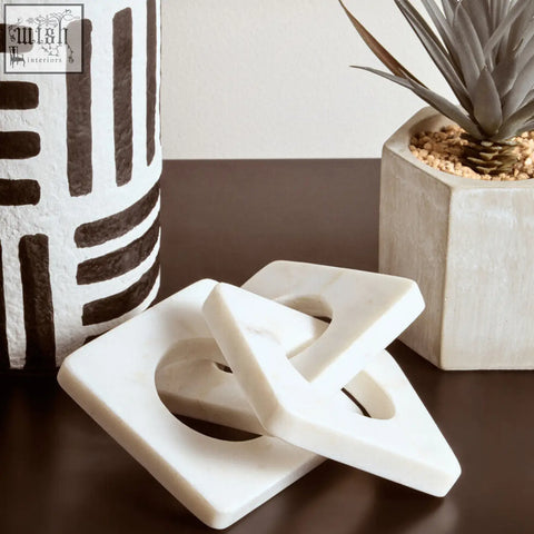 Nason white marble three link chain featuring a white marble geometric sculpture with interlocking square and triangle shapes