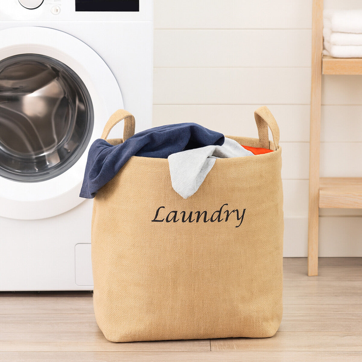 Beige jute hessian laundry bag with black embroidered laundry text and sturdy handles for easy use