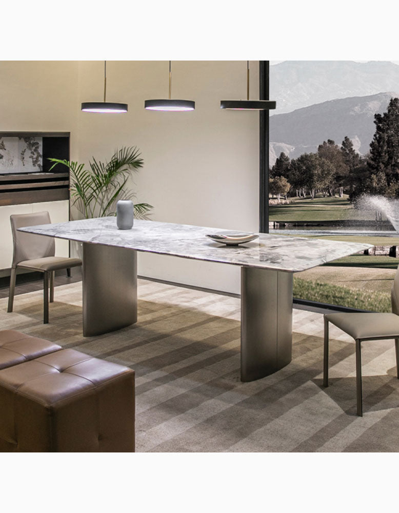 Modern rectangular dining table with polished natural marble top and sleek curved metallic legs for dining table use