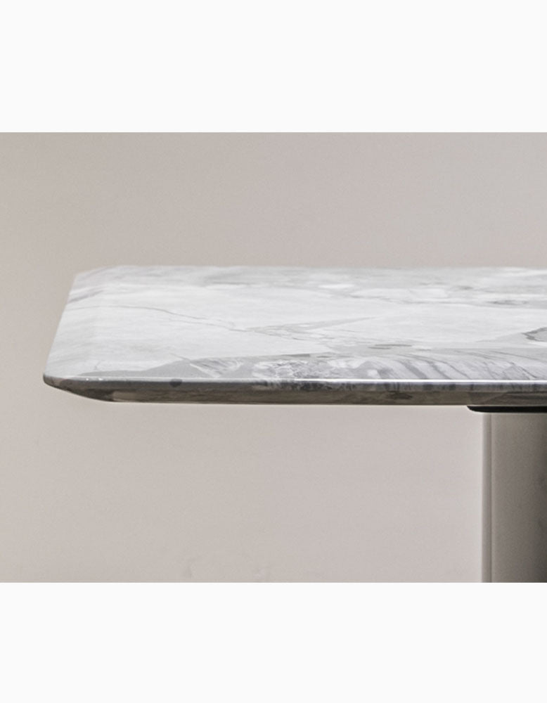 A sleek white natural marble dining table with subtle gray veining and a polished modern finish perfect for dining