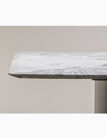 A sleek white natural marble dining table with subtle gray veining and a polished modern finish perfect for dining
