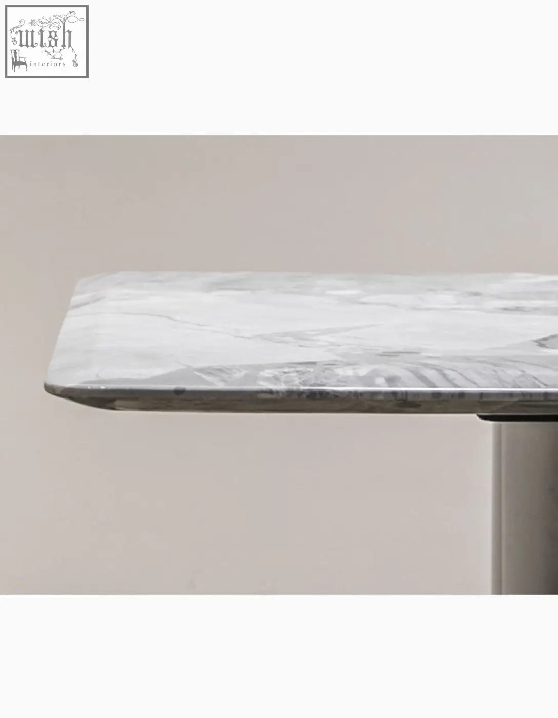 A natural marble dining table with a sleek white marble tabletop and subtle gray veining perfect for any dining space