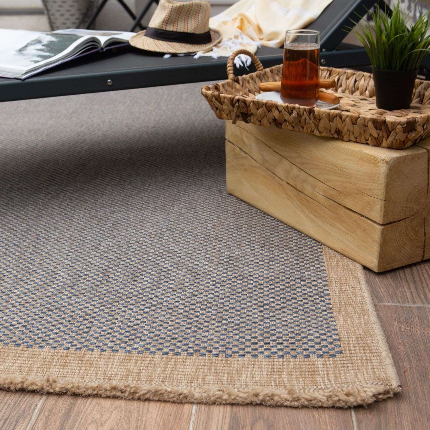 Beige and gray woven nature outdoor rug with textured checkered pattern and frayed edges perfect as an outdoor rug