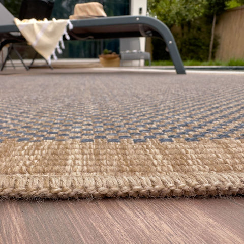 Beige and gray woven nature outdoor rug with textured braided edge perfect for outdoor rug use