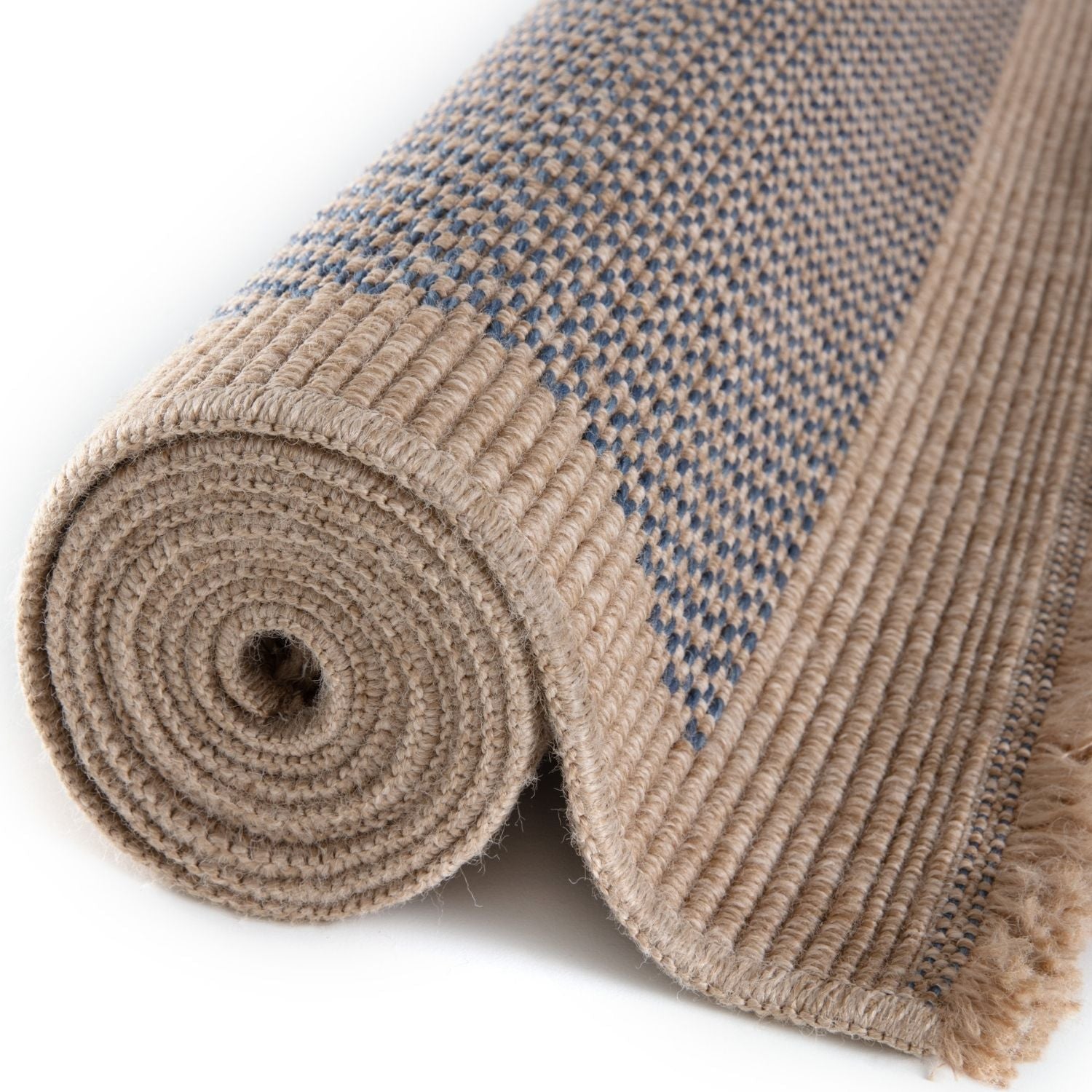 A rolled beige and blue woven nature outdoor rug with textured braided edge perfect for outdoor use