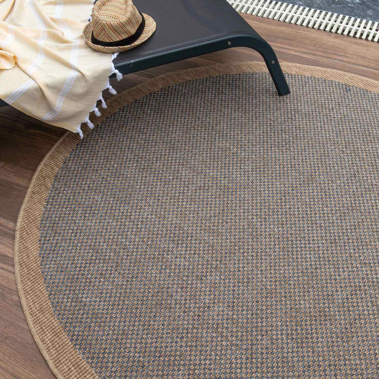 Round woven jute nature outdoor rug with textured pattern and natural beige border in blue outdoor rug style