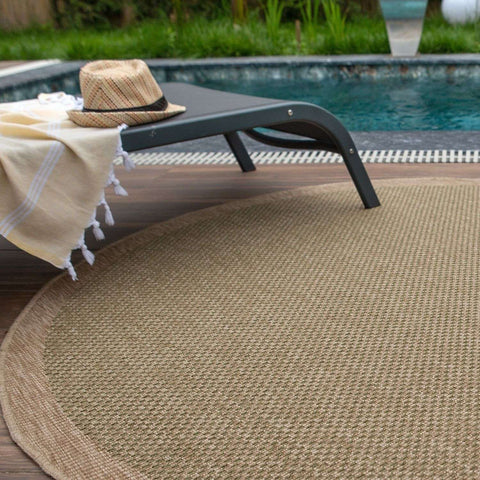 Beige woven nature outdoor rug green with textured braided pattern and rounded edges for outdoor use