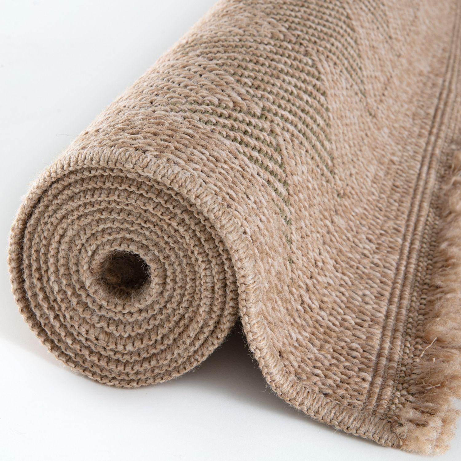 Beige woven nature outdoor rug with textured braided pattern and fringed edges perfect for outdoor rug green spaces