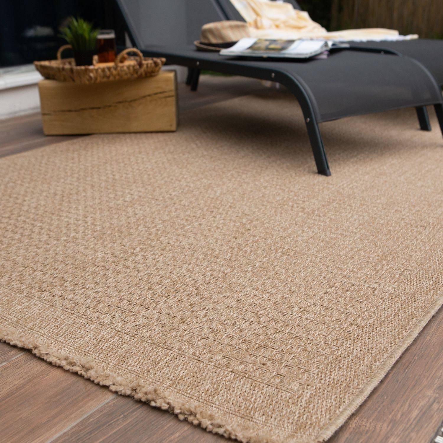 Beige woven jute nature outdoor rug neutral with textured diamond pattern and frayed edges perfect for outdoor use