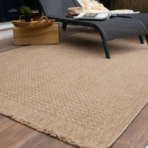 Beige woven jute nature outdoor rug neutral with textured diamond pattern and frayed edges perfect for outdoor use